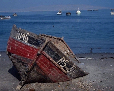 Photo of a broken boat by a shore